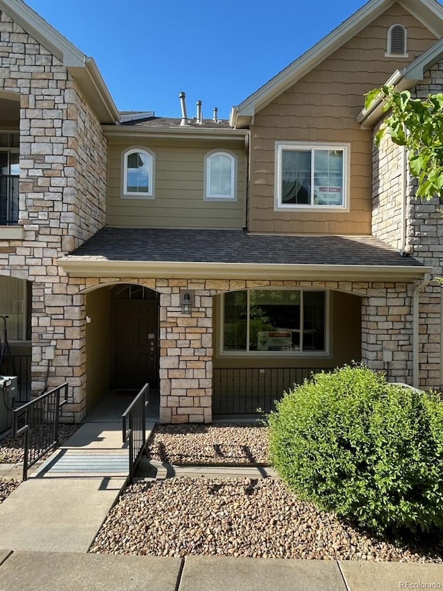 11207 Osage Cir Unit B, Northglenn, CO 80234 - view of front of property featuring stone siding and roof with shingles