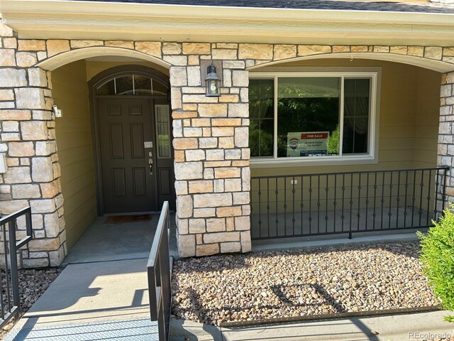 11207 Osage Cir Unit B, Northglenn, CO 80234 - entrance to property featuring stone siding