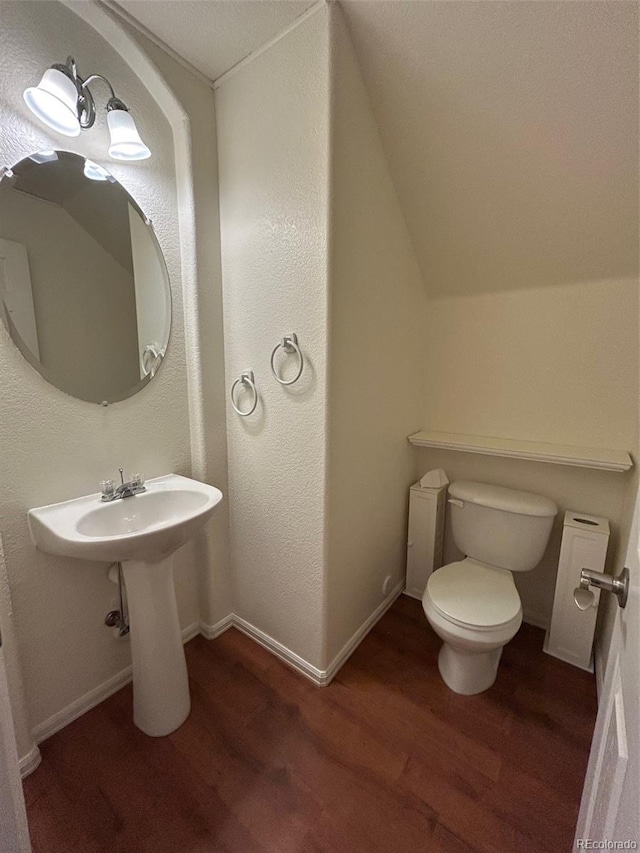 11207 Osage Cir Unit B, Northglenn, CO 80234 - bathroom with wood finished floors, toilet, and vaulted ceiling