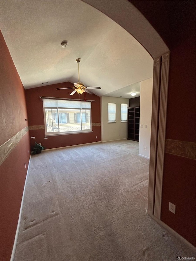 11207 Osage Cir Unit B, Northglenn, CO 80234 - spare room featuring lofted ceiling, a ceiling fan, light carpet, arched walkways, and a smoke detector