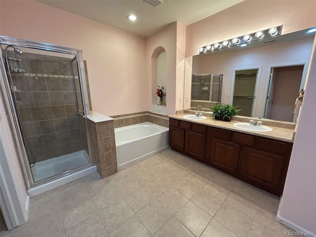 11207 Osage Cir Unit B, Northglenn, CO 80234 - bathroom with a shower stall, a garden tub, tile patterned floors, double vanity, and recessed lighting