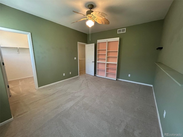 11207 Osage Cir Unit B, Northglenn, CO 80234 - unfurnished bedroom featuring carpet floors, baseboards, a spacious closet, and ceiling fan