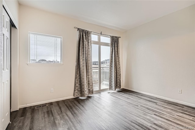 spare room with hardwood / wood-style flooring