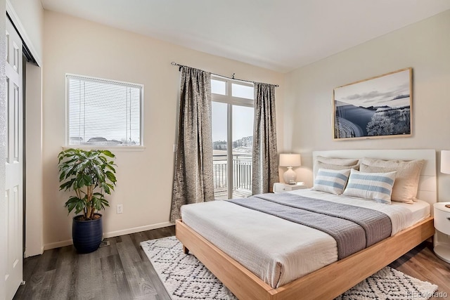 bedroom with multiple windows and dark hardwood / wood-style flooring