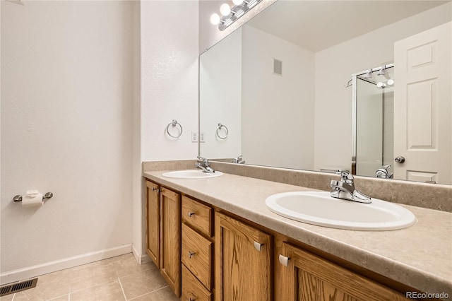 bathroom featuring tile patterned flooring and vanity