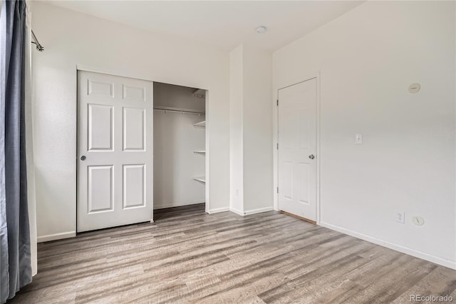 unfurnished bedroom featuring a closet and light hardwood / wood-style flooring