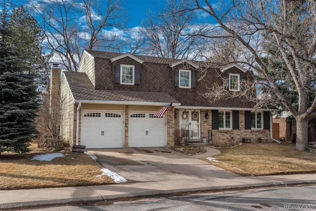 cape cod home with a garage and a front yard