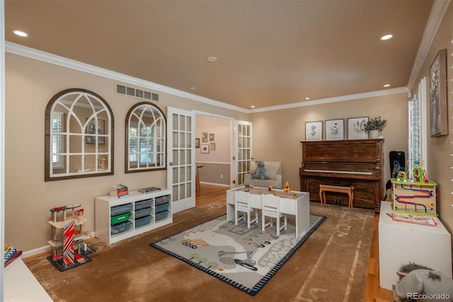 rec room with ornamental molding and french doors