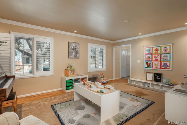 recreation room with crown molding and light hardwood / wood-style floors