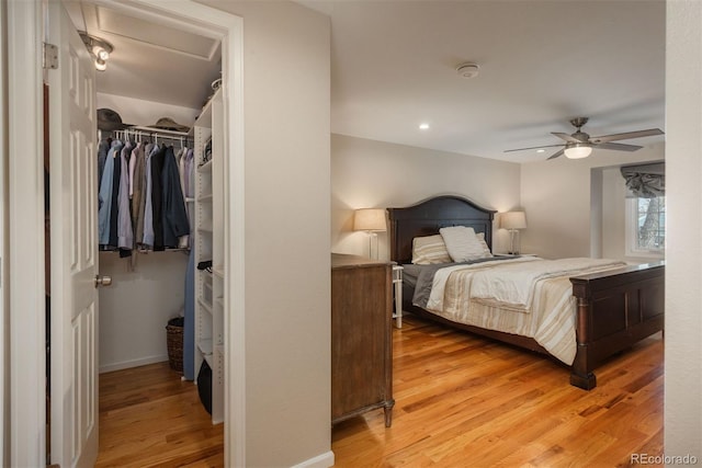 bedroom featuring light hardwood / wood-style floors, a closet, and ceiling fan