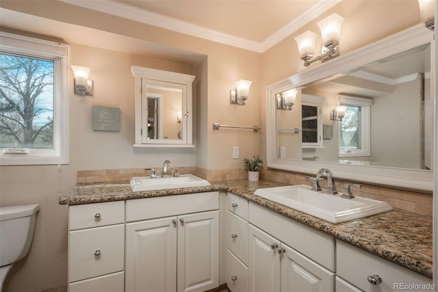 bathroom featuring ornamental molding, vanity, and toilet