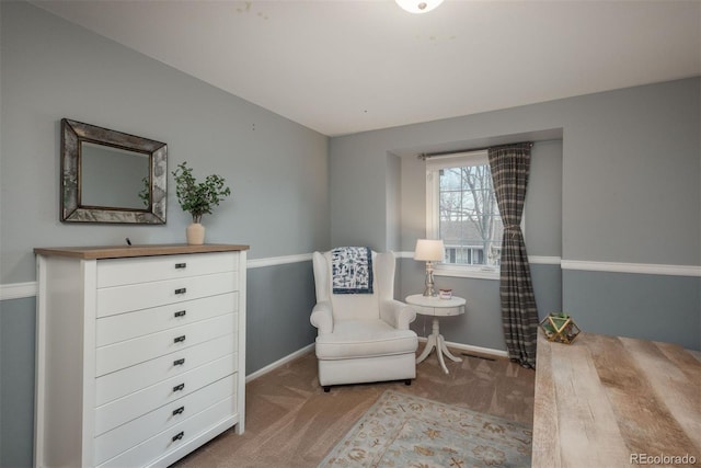 sitting room featuring light carpet and baseboards