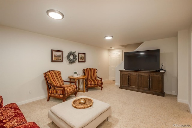 living area featuring baseboards and light colored carpet