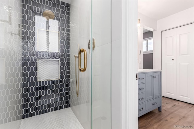 5914 S Kearney St, Centennial, CO 80111 - bathroom with tiled shower, wood finished floors, and vanity