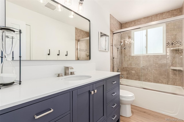 5914 S Kearney St, Centennial, CO 80111 - bathroom featuring vanity, wood finished floors, and bath / shower combo with glass door