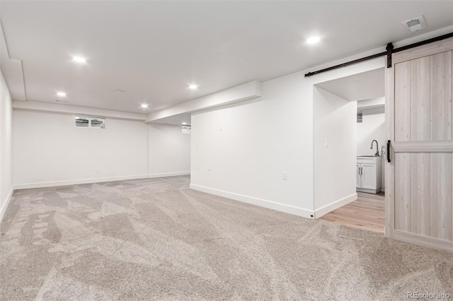 5914 S Kearney St, Centennial, CO 80111 - finished below grade area with light carpet, a barn door, and recessed lighting