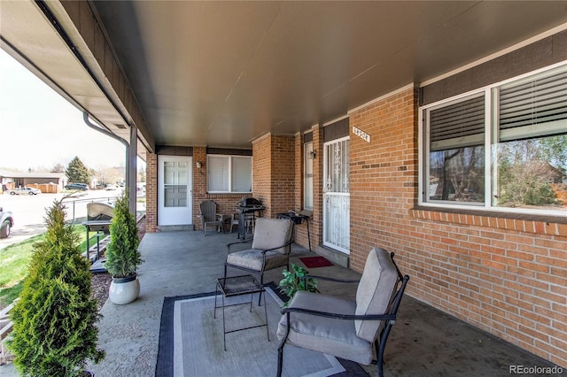 view of patio featuring covered porch and a grill