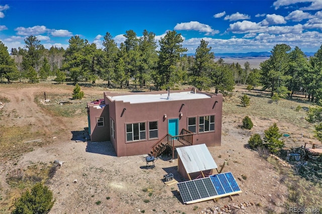 147 Sulky Ct, Hartsel, CO 80449 - back of property with stucco siding and ground mounted solar panels