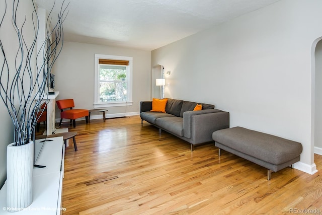 284 S Lafayette St, Denver, CO 80209 - living area with light wood-style flooring, baseboards, and arched walkways