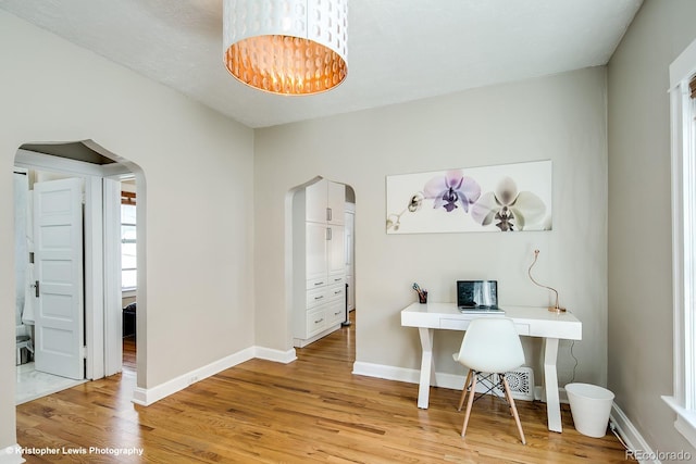 284 S Lafayette St, Denver, CO 80209 - office area with arched walkways, light wood-type flooring, a chandelier, and baseboards