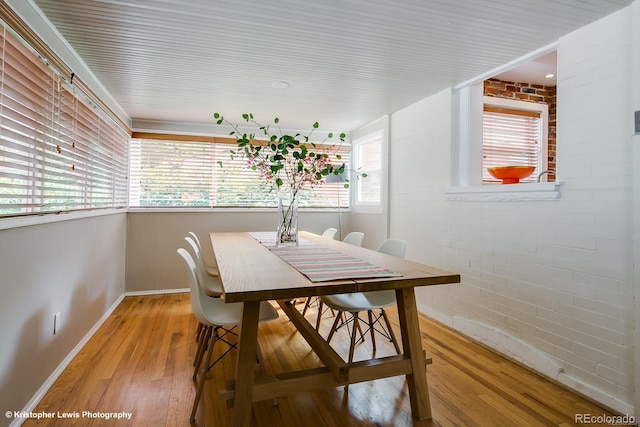 284 S Lafayette St, Denver, CO 80209 - dining room with wood finished floors, baseboards, and brick wall