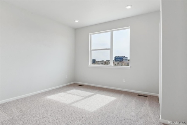 carpeted empty room with baseboards and recessed lighting
