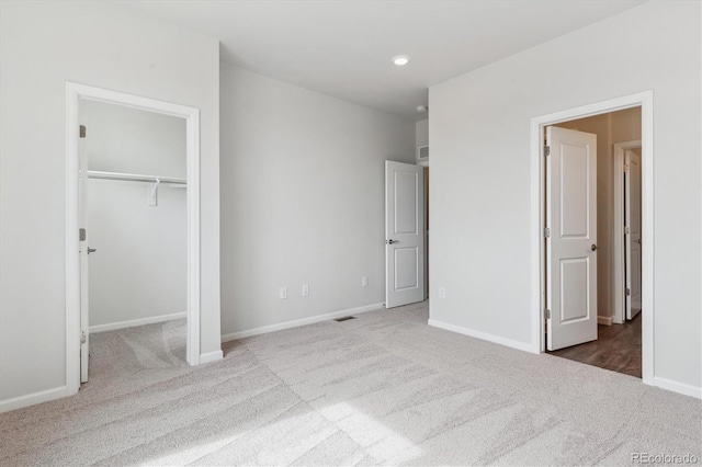 unfurnished bedroom with baseboards, carpet flooring, and visible vents