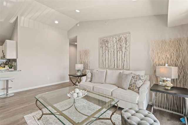 living room featuring hardwood / wood-style floors and vaulted ceiling