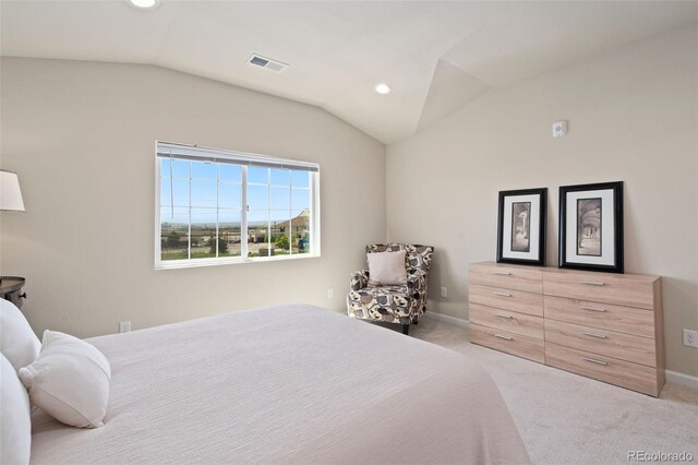 bedroom featuring light carpet and lofted ceiling