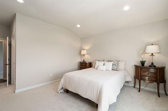 carpeted bedroom with lofted ceiling