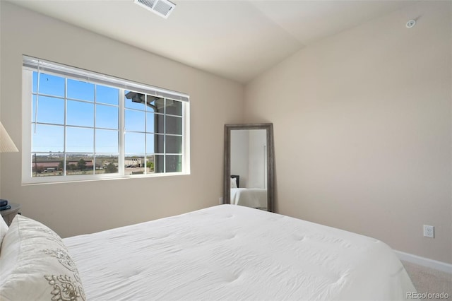 carpeted bedroom featuring vaulted ceiling