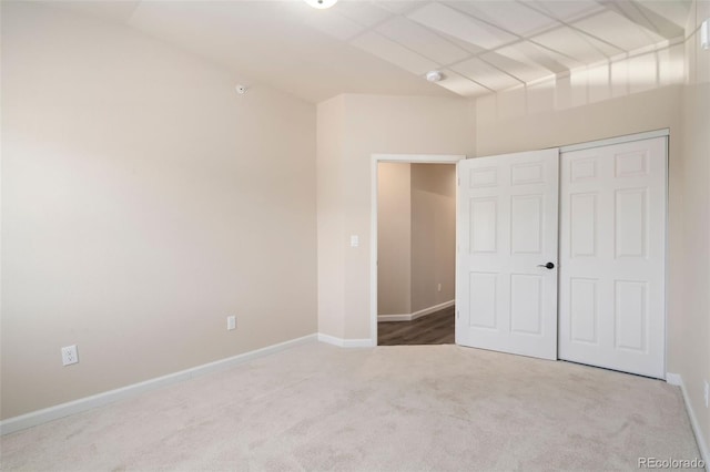 unfurnished bedroom with carpet flooring and a closet