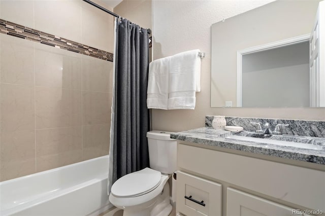 full bathroom with vanity, shower / bath combo, and toilet