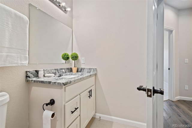 bathroom with vanity and hardwood / wood-style flooring