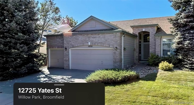 ranch-style house with a garage and a front yard