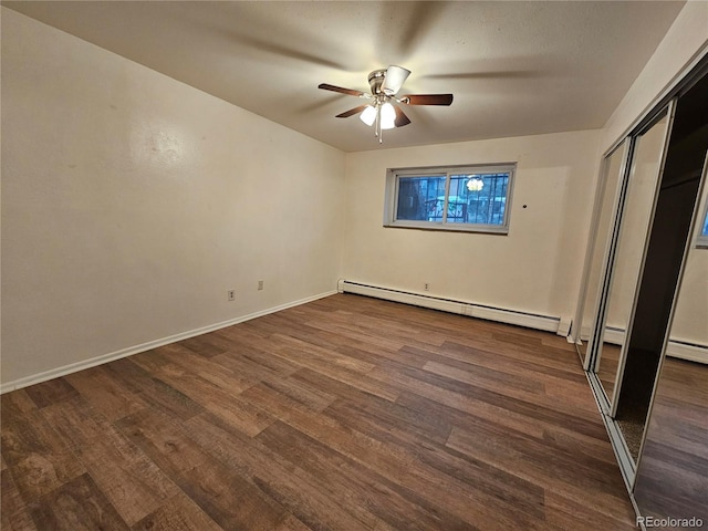 unfurnished bedroom featuring ceiling fan, a closet, dark hardwood / wood-style flooring, and a baseboard radiator