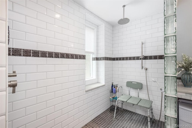 bathroom with tile patterned flooring and tiled shower