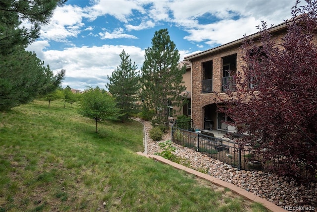 view of yard featuring a balcony