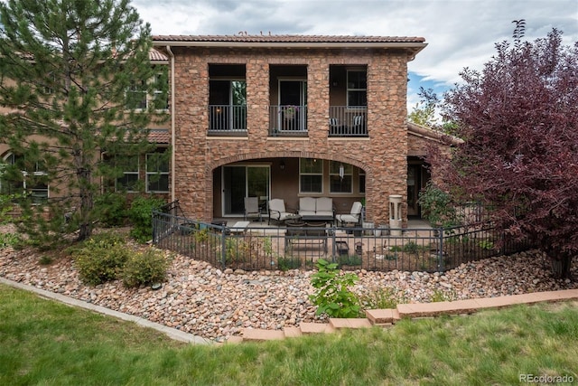 view of front of property with an outdoor living space and a patio