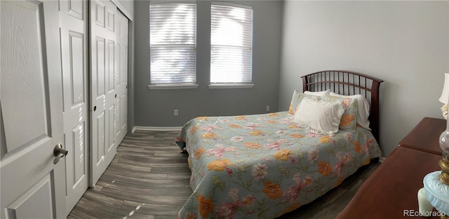 bedroom featuring dark hardwood / wood-style flooring and a closet