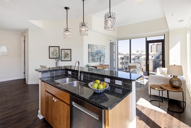 1650 Fillmore St Unit 504, Denver, CO 80206 - kitchen featuring stainless steel dishwasher, baseboards, open floor plan, a center island with sink, and a sink