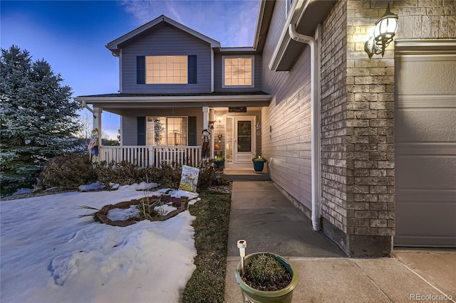 view of front of house featuring a porch and a garage