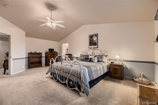 carpeted bedroom with ceiling fan and vaulted ceiling