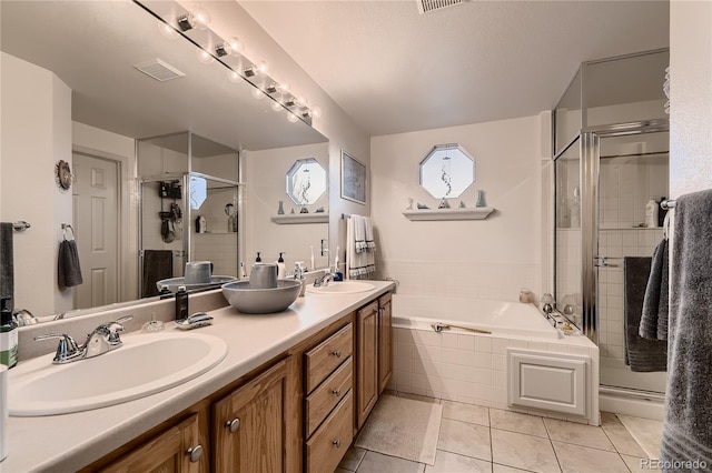 bathroom featuring a textured ceiling, vanity, tile patterned floors, and independent shower and bath