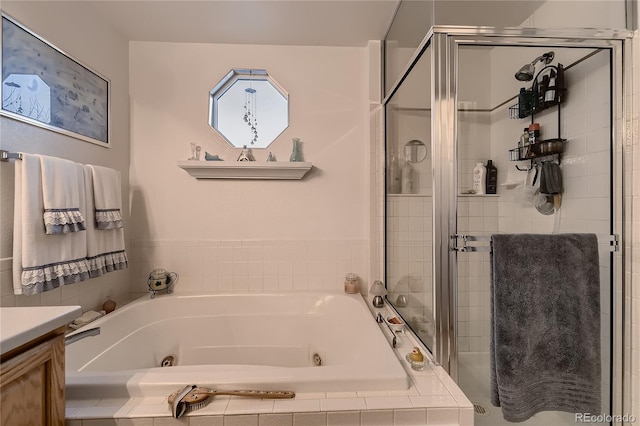 bathroom featuring vanity and independent shower and bath