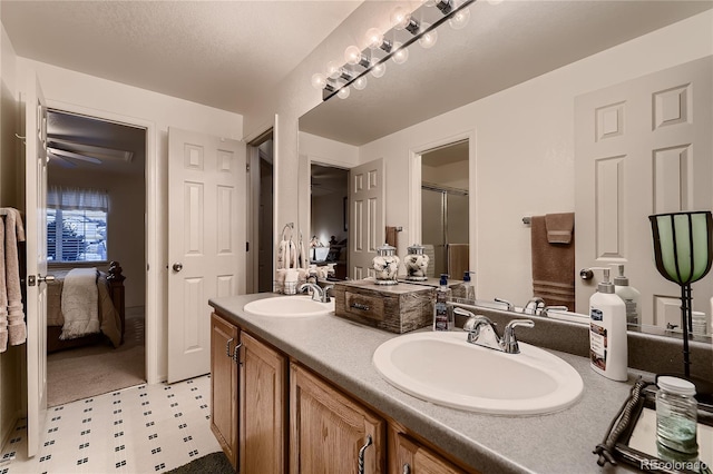 bathroom with a shower with door and vanity