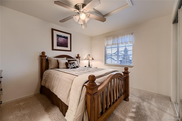 bedroom featuring light colored carpet and ceiling fan