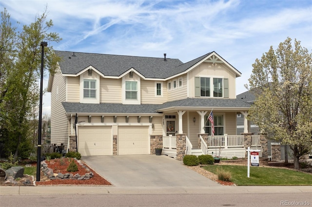 craftsman inspired home with covered porch, roof with shingles, stone siding, concrete driveway, and a garage