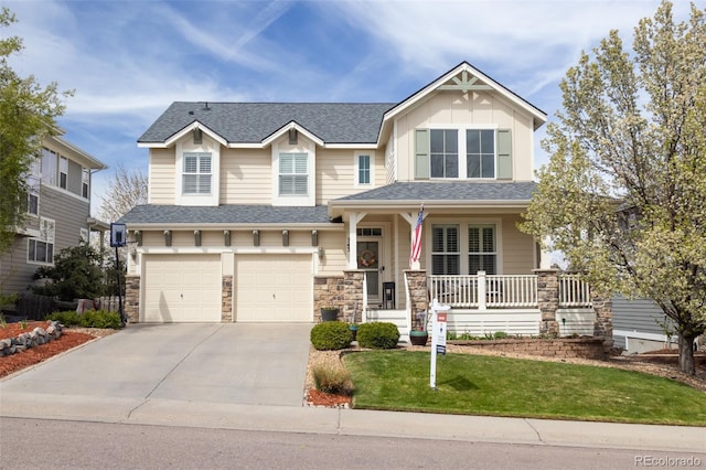 craftsman house with a porch, an attached garage, stone siding, concrete driveway, and a front lawn