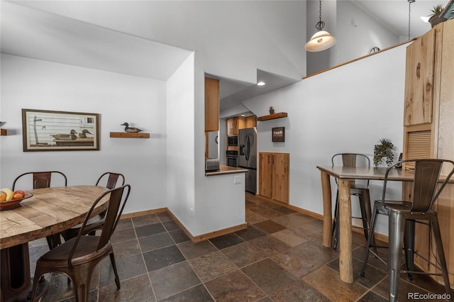 dining area with a high ceiling